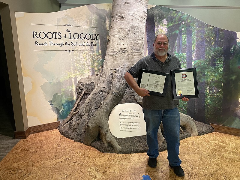 Jim Gann holds up two certificates he received during his retirement party. Gann began work at Logoly State Park in 1977 and has served as the park’s Superintendent since 1991.