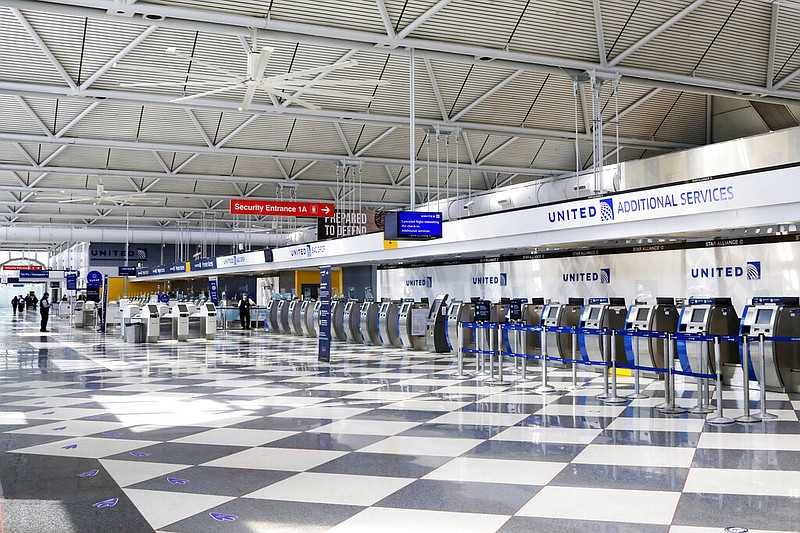 FILE - In this June 25, 2020, file photo, rows of United Airlines check-in counters at O'Hare International Airport in Chicago are unoccupied amid the coronavirus pandemic.