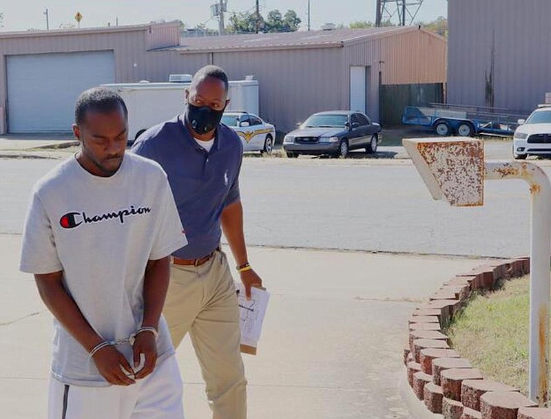 Bryant Lamont Smith, left, is escorted in the W.C. “Dub” Brassell Detention Center by Jefferson County sheriff’s office Capt. Yohance Brunson after being returned from Kansas Tuesday morning. Smith was arrested Friday in Kansas after a three-week search. 
(Special to The Commercial)