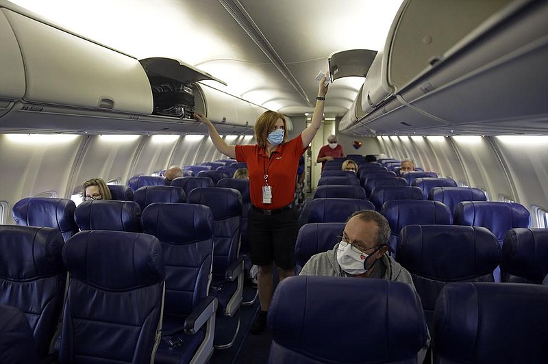 A Southwest Airlines flight attendant prepares a plane for takeoff in May at Kansas City International Airport in Kansas City, Mo. The airline plans to begin offering service between Little Rock and Atlanta.
(AP)