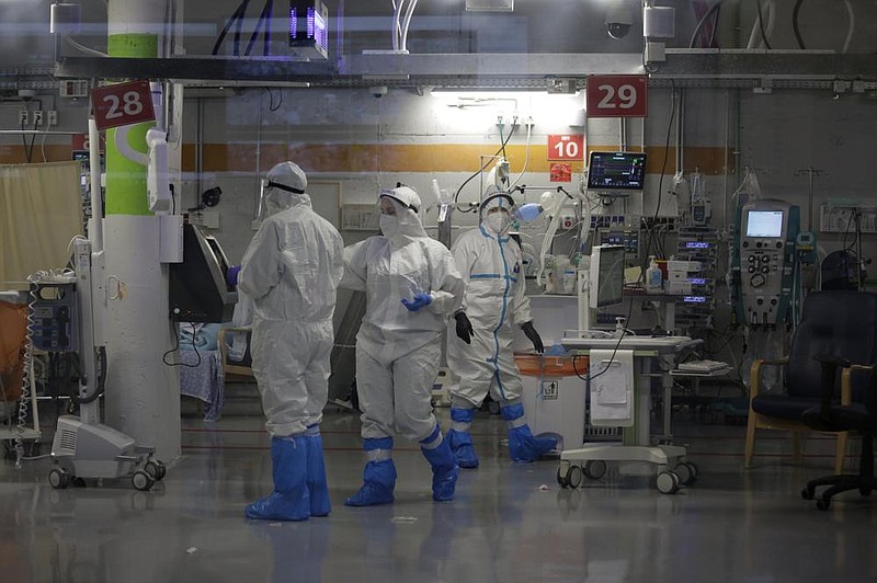 Medical professionals in full protective equipment work Wednesday in the critical care coronavirus unit, which was built in an underground parking garage at Sheba Medical Center in Ramat Gan, Israel, amid a spike in covid-19 cases.
(AP/Maya Alleruzzo)