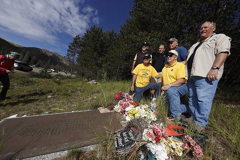 Members of the 1970 Wichita State football team stand around a plaque for their teammates who died in an airplane crash near Loveland Pass, Colo., on Oct. 2, 1970. Wreckage from the plane, which was one of two being used to take the team to Logan, Utah, for a game against Utah State, is still scattered on the mountain top nearly 50 years after the crash.
(AP/David Zalubowski)