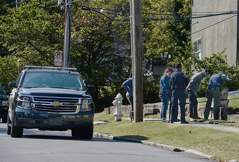 Fayetteville Police talk to a man in custody after a standoff at an apartment complex in Fayetteville. (NWA Democrat-Gazette/ANDY SHUPE)
