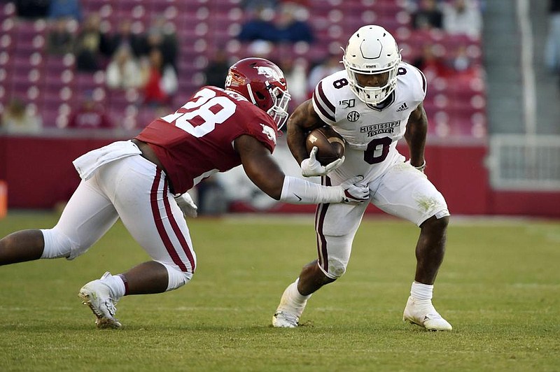 Mississippi State’s Kylin Hill (right) rushed for a career-high 234 yards and three touchdowns, averaging more than 11 yards per carry, during the Bulldogs’ 54-24 victory at Arkansas last season.
(AP file photo)
