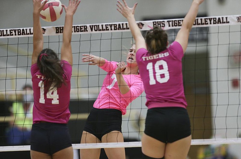 Fort Smith Southside’s Olivia Melton (middle) spikes the ball between two Bentonville defenders Thursday during the Lady Rebels’ 25-11, 25-19, 27-25 victory over the Lady Tigers in Bentonville. See nwaonline.com/201001Daily/ for today’s photo gallery.
(NWA Democrat-Gazette/Charlie Kaijo)