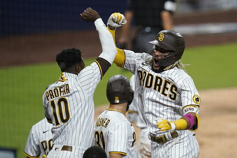 San Diego’s Fernando Tatis Jr. (right) celebrates with Jurickson Profar on Thursday after Tatis hit a two-run home run during the seventh inning of the Padres’ 11-9 victory over the St. Louis Cardinals at Petco Park in San Diego.
(AP/Gregory Bull)