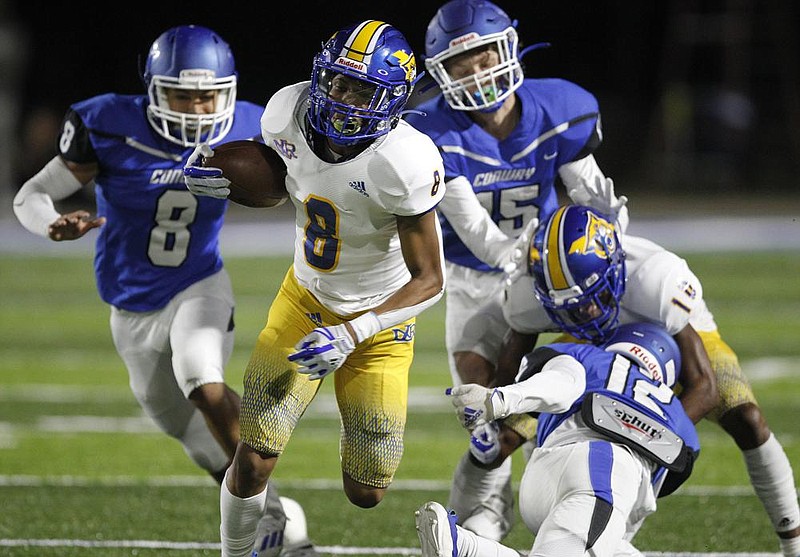 North Little Rock wide receiver Felix Wade (8) runs through Conway defenders during the second quarter Friday at McConnell Stadium in Conway. North Little Rock won 39-37. More photos at arkansasonline.com/103nlrconway/.
(Arkansas Democrat-Gazette/Thomas Metthe) story.lead_photo.caption