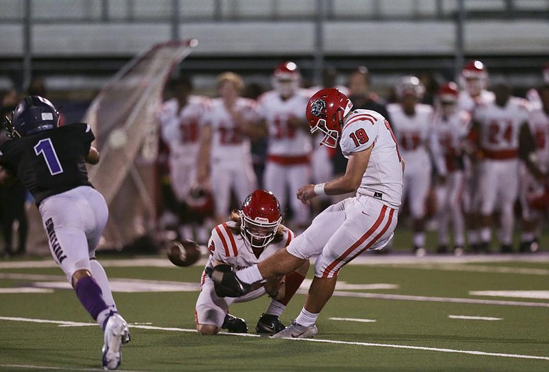 Slate Stanton (right) kicks the winning field goal to give Fort Smith Northside a 33-30 victory over host Fayetteville on Friday. More photos at arkansasonline.com/103northside/.
(NWA Democrat-Gazette/Charlie Kaijo)