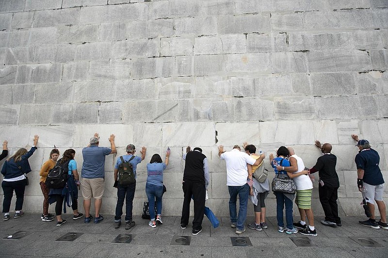 People pray at the base of the Washington Monument Sept. 26 during the Prayer March at the National Mall.
(AP/Jose Luis Magana)
