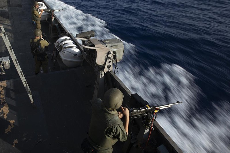 Soldiers take their positions aboard the Israeli navy ship Lahav during a tour of Israel’s offshore Leviathan gas field Tuesday in the Mediterranean Sea. More photos at arkansasonline.com/104lahav/.
(AP/Ariel Schalit)