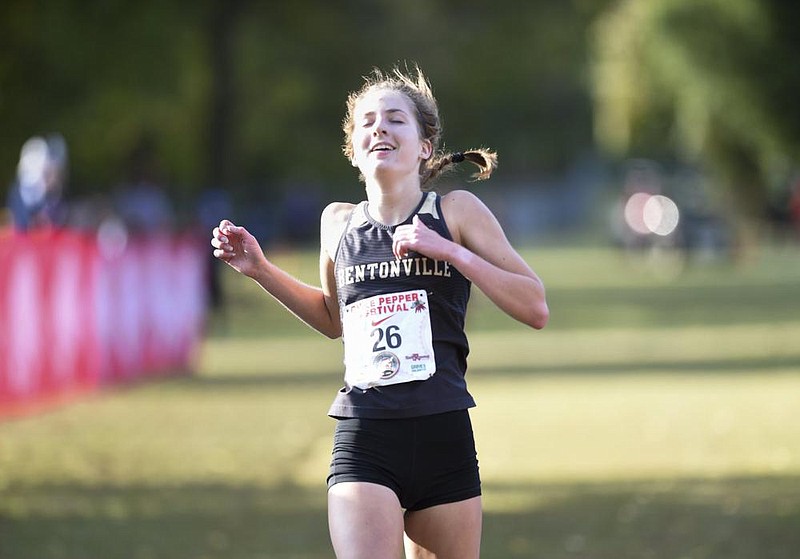 1st place finisher Emily Robinson crosses the finish line, Saturday, October 3, 2020 during the Chile Pepper Cross Country Festival at the University of Arkansas Cross Country Course in Fayetteville. Bentonville High School placed first in both the boys and girls run. 2011 was the last year they placed first. Dawson Mayberry completed his run in 15:15.8 leading his team to edge past Fayetteville by one point, 57-56. Emily Robinson completed her run at 18:30.8 to help give the Bentonville girls a distant lead of 30 points over runner up Fayetteville's 55. Check out nwaonline.com/201004Daily/ for today's photo gallery. 
(NWA Democrat-Gazette/Charlie Kaijo)