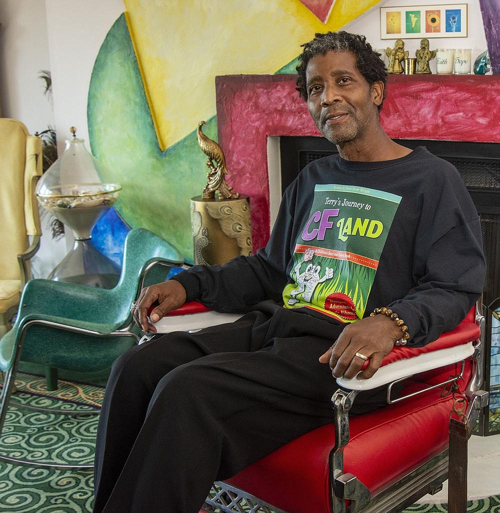 Terry Wright sits in the barber’s chair at his North Little Rock home. Wright, whowas diagnosed with cystic fibrosis when he was 54, won a $10,000 grant in July from the national Cystic Fibrosis Foundation. (Arkansas Democrat-Gazette/Cary Jenkins)