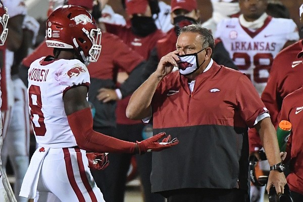 Arkansas coach Sam Pittman talks to wide receiver Mike Woods (8) during the second half of the team's NCAA college football game against Mississippi State in Starkville, Miss., Saturday, Oct. 3, 2020. Arkansas won 21-14. (AP Photo/Thomas Graning)