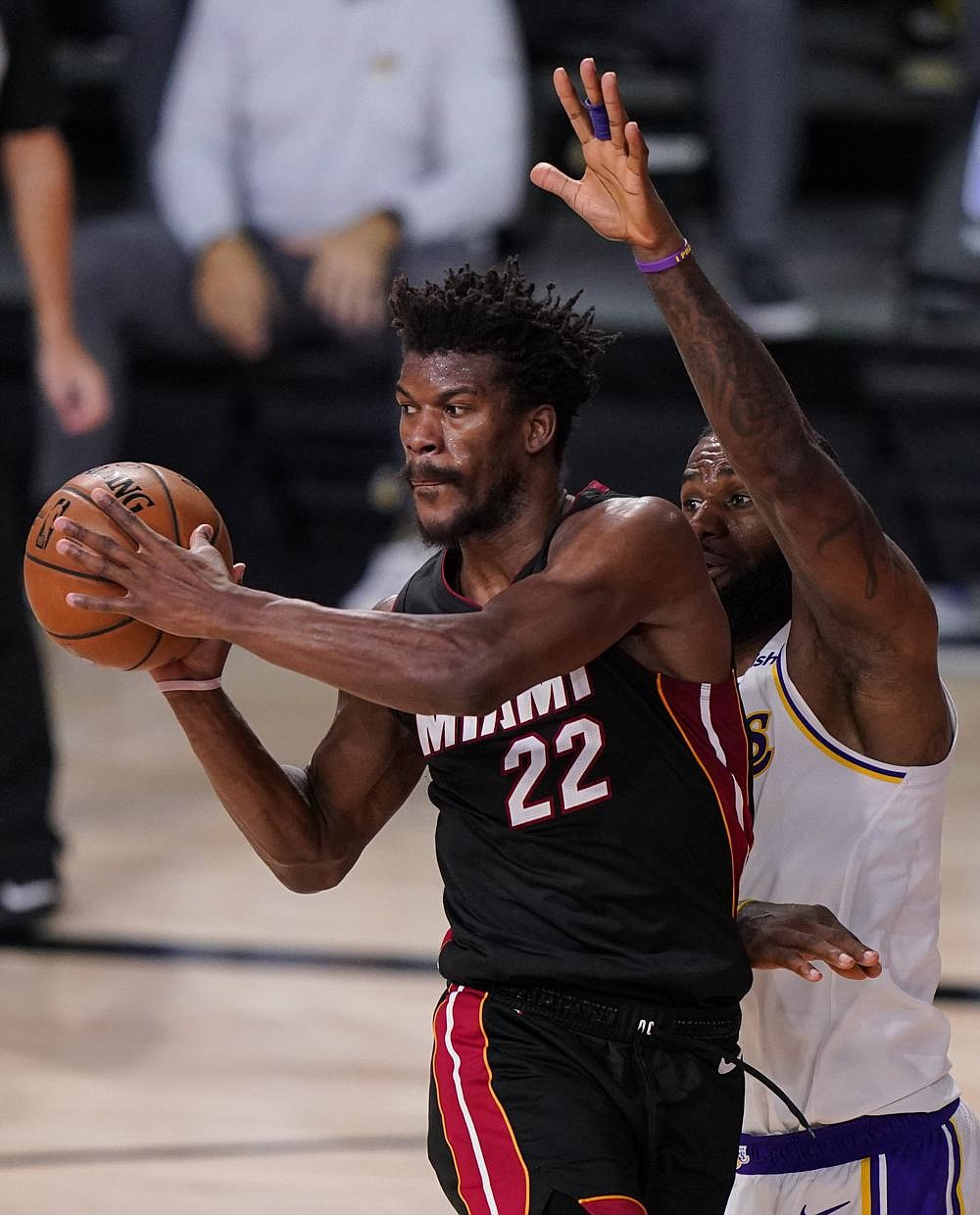 Miami Heat guard Jimmy Butler makes a pass as LeBron James of the Los Angeles Lakers defends during the second half of Game 3 of the NBA Finals on Sunday in Lake Buena Vista, Fla. Butler had 40 points, 11 rebounds and 13 assists as the Heat beat the Lakers 115-104 to get within 2-1 in the series.
(AP/Mark J. Terrill)