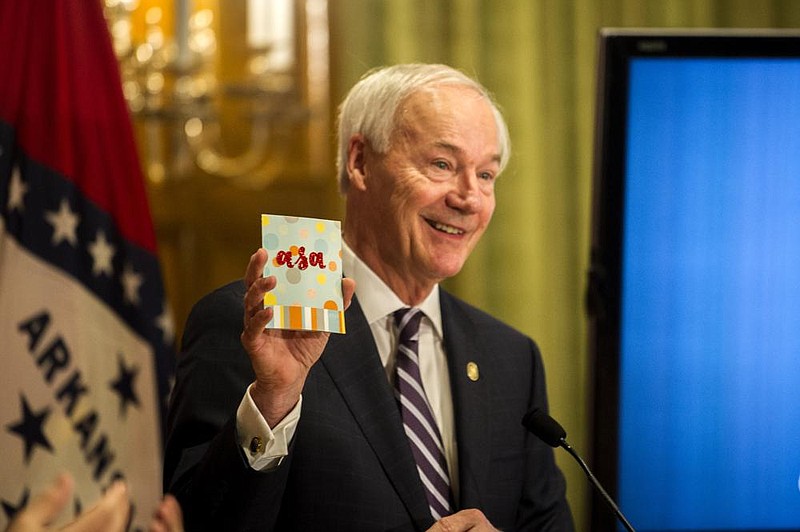 Governor Hutchinson shows a card he received from a child asking him about Halloween celebrations during a weekly address on Arkansas’ response to COVID-19 on Tuesday, Oct. 6. (Arkansas Democrat-Gazette / Stephen Swofford)