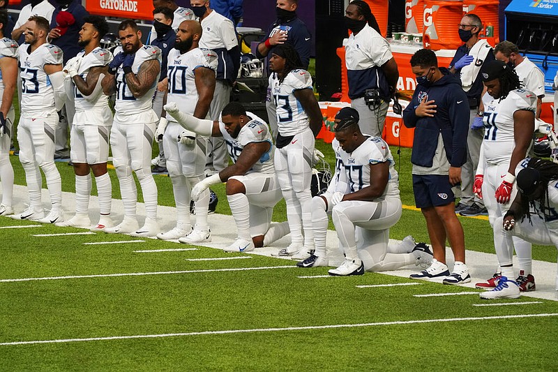 FILE - In this Sept. 27, 2020, file photo, members of the Tennessee Titans take part in the national anthem before an NFL football game against the Minnesota Vikings, in Minneapolis.