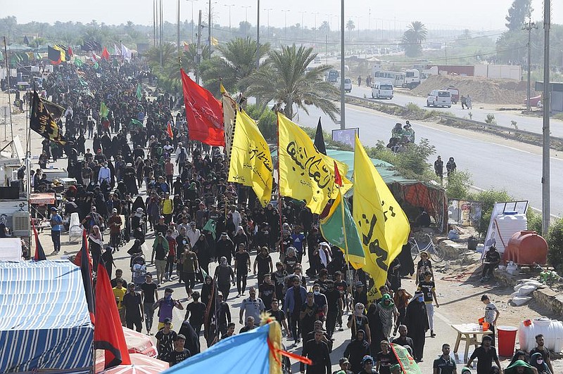 Shiite pilgrims arrive Tuesday in Karbala, Iraq, for the Arbaeen ritual, the end of the 40-day mourning period marking the mar- tyrdom of Imam Hussein, the Prophet Muhammad’s grandson in the seventh century. 
(AP/Anmar Khalil) 