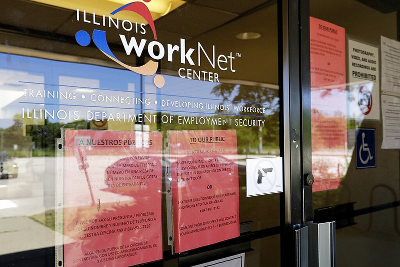 FILE - In this June 11, 2020, file photo, information signs are displayed at the closed Illinois Department of Employment Security WorkNet center in Arlington Heights, Ill. U.S. employers advertised for slightly fewer jobs in August while their hiring ticked up modestly. The Labor Department said Tuesday, Oct. 6, 2020, that the number of U.S. job postings on the last day of August dipped to 6.49 million, down from 6.70 million July. (AP Photo/Nam Y. Huh, File)

