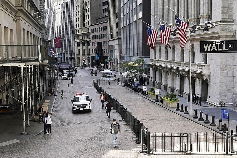 A police car patrols Wednesday in front of the New York Stock Exchange. Stocks rose on renewed optimism about an agreement on additional economic stimulus measures.
(AP/Mark Lennihan)