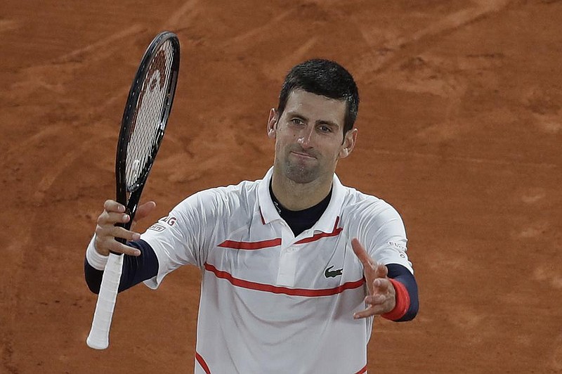 Novak Djokovic celebrates winning his quarterfinal match at the French Open on Wednesday against Pablo Carreno Busta in Paris.
(AP/Alessandra Tarantino)