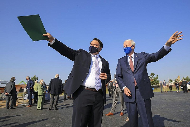 FILE — Revolution CEO Sean Whiteley (left) talks with Gov. Asa Hutchinson before a news conference Wednesday to announce the expansion of the company’s facility at the Little Rock Port in this Oct. 7, 2020 file photo. Revolution is the parent company of Delta Plastics. 
(Arkansas Democrat-Gazette/Staton Breidenthal)