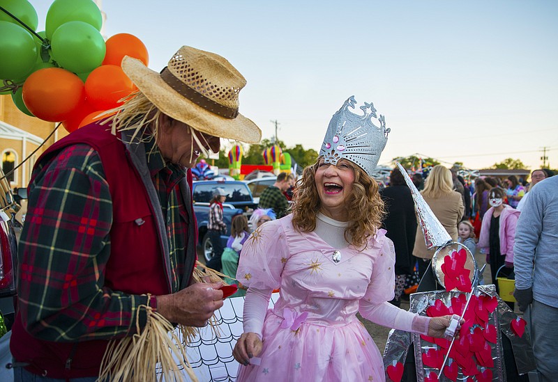In this Nov. 1, 2019 File Photo, Members of First Baptist Church, dressed as Glinda the Good Witch of the North and the Scarecrow from “The Wizard of Oz,” oversee a station at the church’s annual Trunk-or-Treat on Halloween night at the corner of Pine and E. Main Street. ADH guidelines have placed trunk-or-treat events as a Moderate Risk Activity this year, as long as the treats are not passed out by hand.