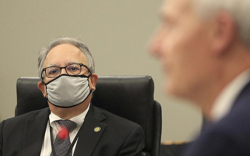 Gov. Asa Hutchinson, reacting to the spike in coronavirus cases Thursday during his Cabinet meeting in North Little Rock, said “individual discipline,” not further mandates, is the “only way we can navigate through this crisis.” At left is Health Secretary Jose Romero.
(Arkansas Democrat-Gazette/Staton Breidenthal)