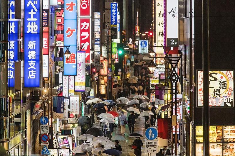 People walk Thursday through a street filled with bars, restaurants and other businesses in Tokyo.
(AP/Hiro Komae)