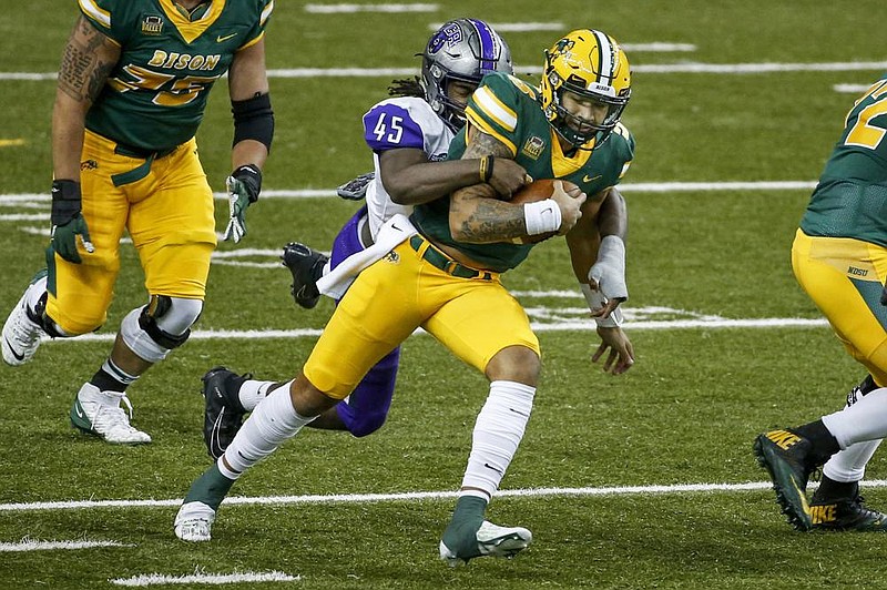 Central Arkansas linebacker Dre Matthews (left) tackles North Dakota State quarterback Trey Lance during an Oct. 3 matchup in Fargo, N.D. The Bears have forced 11 turnovers and recorded 13 sacks heading into today’s game against Arkansas State in Jonesboro.
(AP/Bruce Kluckhohn) story.lead_photo.caption