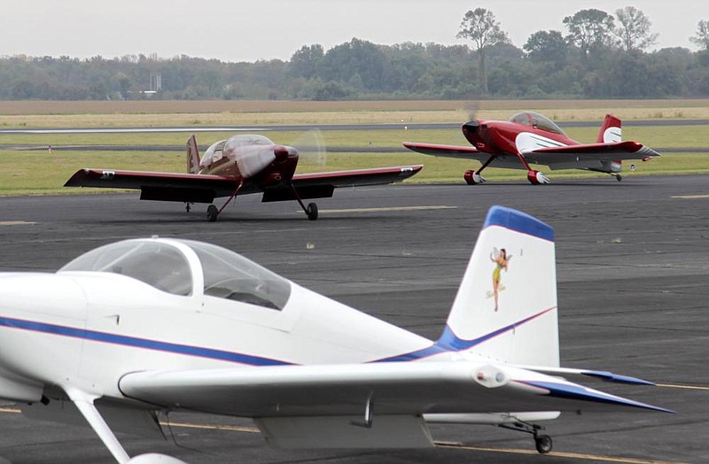 Two of the 22 experimental aircraft fly onto the tarmac next to the Grider Field airfield terminal after morning maneuvers for this weekend’s formation flying clinic taxi. Many of the aircraft were built by the owners, while some were bought from the original owner/builders. The experimental aircraft designation refers to aircraft that are primarily assembled from kits sold directly to the public. More photos at arkansasonline.com/1010pbair/. 
(Pine Bluff Commercial/Dale Ellis)