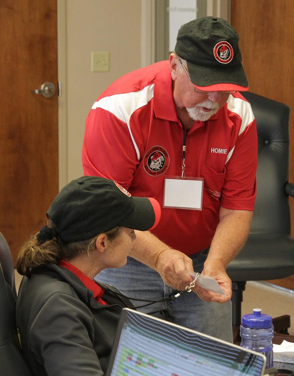 Angela “Scrubs” Palmer, a neurosurgery resident at the University of Arkansas for Medical Sciences, is presented with her green formation flight sticker by Bulldog Formation Flight Team member Jerry “Homie” Homsley, indicating that she has passed her wingman check-ride and has qualified for her FAA Formation Card.
(Pine Bluff Commercial/Dale Ellis)