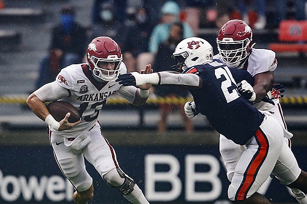 Arkansas quarterback Feleipe Franks (13) scrambles for yardage as Auburn defensive back Smoke Monday (21) tries to tackle him during the first quarter of an NCAA college football game on Saturday, Oct. 10, 2020, in Auburn, Ala. (AP Photo/Butch Dill)


