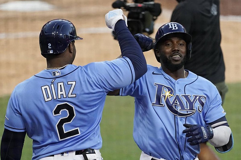 Randy Arozarena is congratulated by teammate Yandy Diaz after hitting a solo home run against Houston Astros pitcher Framber Valdez during the fourth inning in Game 1 of the American League Championship Series. Arozarena’s home run proved to be the difference in a 2-1 victory. 
(AP/Ashley Landis) 