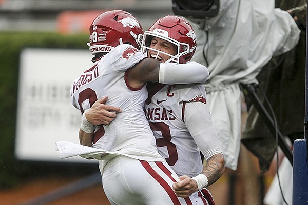 Arkansas quarterback Feleipe Franks (13) celebrates with wide receiver Mike Woods (8) after a touchdown against Auburn during the second quarter of an NCAA college football game on Saturday, Oct. 10, 2020, in Auburn, Alabama. (AP Photo/Butch Dill)