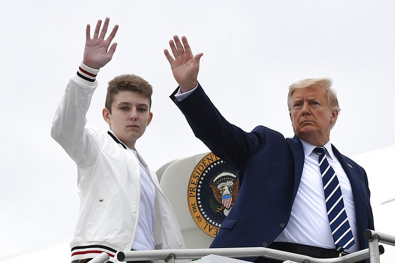 President Donald Trump and his son, Barron Trump, wave from the top of the steps to Air Force One at Morristown Municipal Airport in Morristown, N.J., in this Aug. 16, 2020, file photo.
