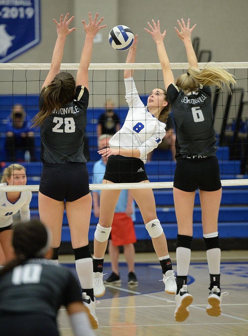 Rogers' Brooke Park (8) sends the ball over the net Tuesday, Oct. 13, 2020, as Bentonville's Allison Oliphant (28) and Gloria Cranney (6) defend during play in King Arena in Rogers. Visit nwaonline.com/201014Daily/ for today's photo gallery. 
(NWA Democrat-Gazette/Andy Shupe)