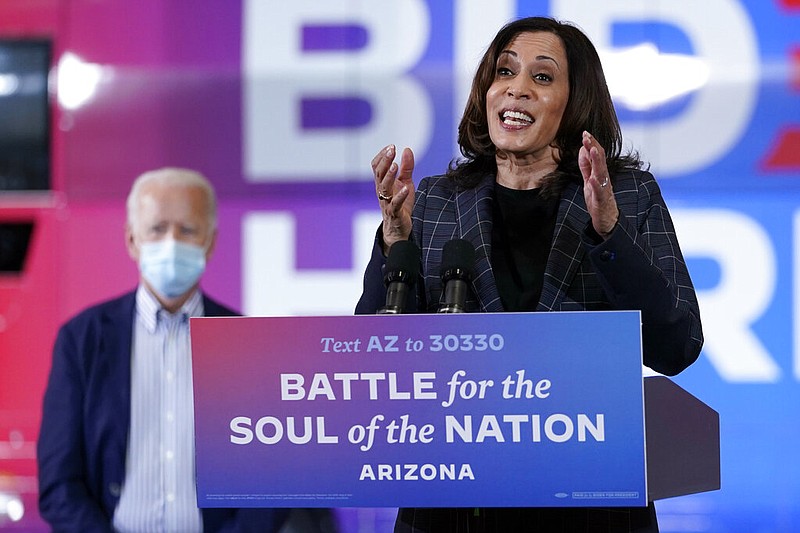 In this Oct. 8, 2020, photo, Democratic vice presidential candidate Sen. Kamala Harris, D-Calif., speaks at Carpenters Local Union 1912 in Phoenix, as Democratic presidential candidate former vice president Joe Biden listens.