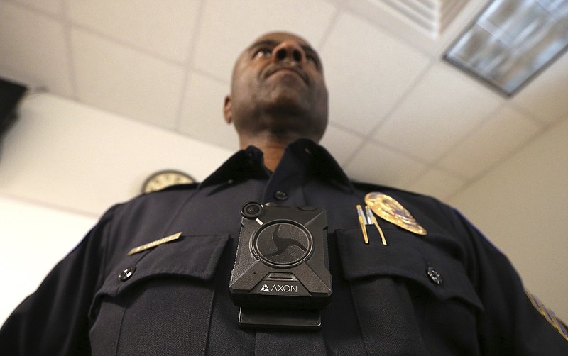 A police officer shows off the Axon Body 2 body camera in this July 2019 file photo.