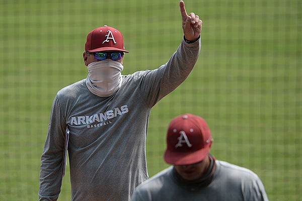 Arkansas coach Dave Van Horn gestures Friday, Sept. 18, 2020, to a friend in the stands during practice at Baum-Walker Stadium in Fayetteville. 