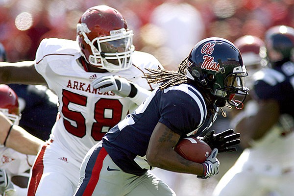 Ole Miss running back Dexter McCluster carries the ball past Arkansas defensive end Damario Ambrose during the second quarter Saturday Oct. 24, 2009, at Vaught-Hemingway Stadium in Oxford, Miss.