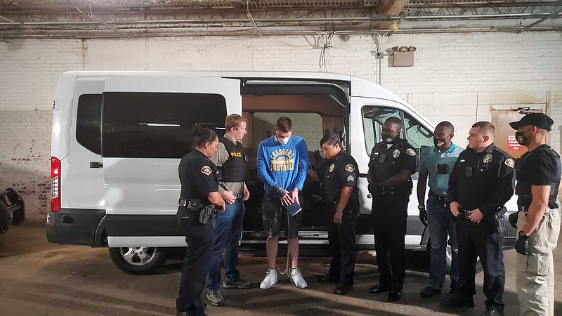 Jory Worthen is escorted by a host of police officers as he arrives at the Camden Police Department Thursday afternoon. Worthen is charged with two counts of capital murder related to the homicides of Alyssa Cannon and her son Braydon Ponder. (Bradly Gill/Camden News)