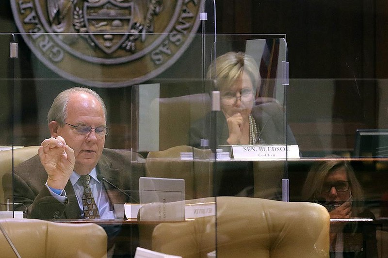 Sen. Terry Rice (left), R-Wadron, asks a question of Lorie Tudor, director of the Arkansas Department of Transportation (right, seen in reflection) about the ARDOT budget as committee co-chair, Sen. Cecile Bledsoe (center), R-Rogers, listens during the second day of budget hearings on Wednesday, Oct. 14, 2020, at the State Capitol in Little Rock. 
(Arkansas Democrat-Gazette/Thomas Metthe)