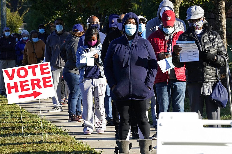 Early voters line up to cast their ballots at the South Regional Library polling location in Durham, N.C., Thursday, Oct. 15, 2020. (AP Photo/Gerry Broome) story.lead_photo.caption