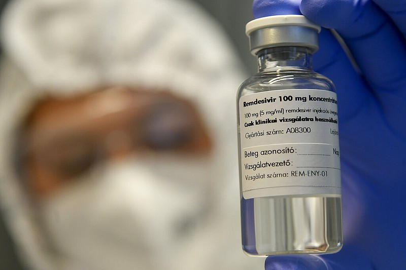 A bottle containing the drug Remdesivir is held by a health worker at the Institute of Infectology of Kenezy Gyula Teaching Hospital of the University of Debrecen in Debrecen, Hungary, Thursday Oct. 15, 2020. A large study led by the World Health Organization released on Friday, Oct. 16, 2020, suggests that the antiviral drug did not help hospitalized covid-19 patients, in contrast to an earlier study that made the medicine a standard of care in the United States and many other countries. The results do not negate the previous ones, and the WHO study was not as rigorous as the earlier one led by the U.S. National Institutes of Health. But they add to concerns about how much value the pricey drug gives because none of the studies have found it can improve survival. (Zsolt Czegledi/MTI via AP)

