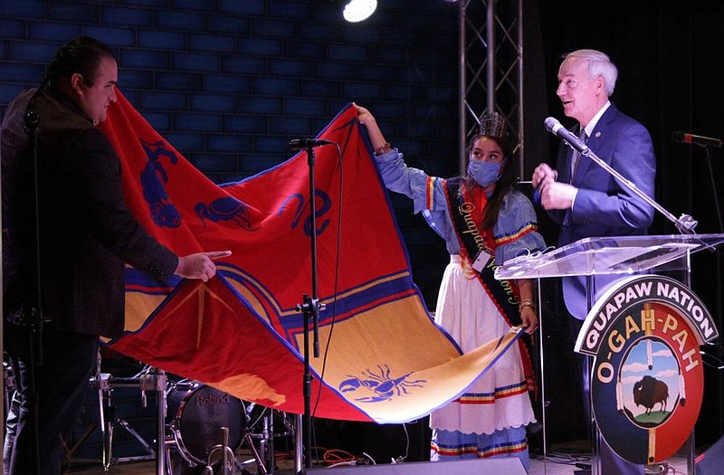 Quapaw Chairman Joseph Tali Byrd (left) and Tribal Princess Kristal Glass present Gov. Asa Hutchinson with a tribal blanket, which Byrd said is one of the highest honors the Quapaw Nation can bestow. More photos at arkansasonline.com/1016pbcasino/. 
(Pine Bluff Commercial/Dale Ellis)
