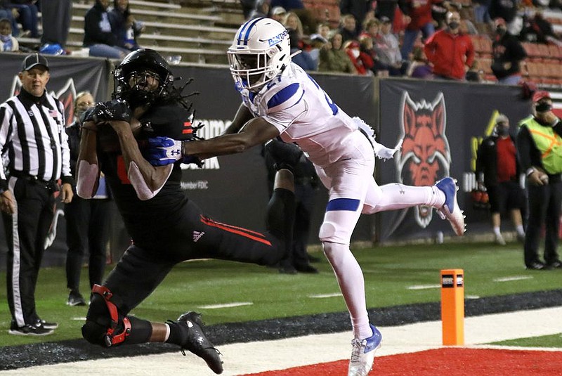 Arkansas State wide receiver Dahu Green (left) pulls in a 20-yard touchdown reception in front of Georgia State cornerback Jaylon Jones during the second quarter of Thursday night’s game.
(Arkansas Democrat-Gazette/Thomas Metthe)