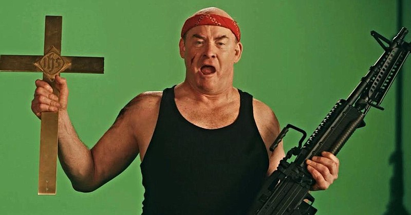 In the parody “Faith-Ba$ed,” David Koechner stars as Butch Savage, an ’80s action star who takes on the role of God in a cynical movie made by two 30-something Los Angelenos to cash in on the demand for Christian-theme films.