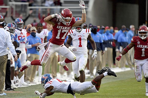Arkansas defensive back Hudson Clark (17) leaps over Ole Miss running back Tylan Knight (4) as he returns an interception during the second half of an NCAA college football game Saturday, Oct. 17, 2020, in Fayetteville. (AP Photo/Michael Woods)


