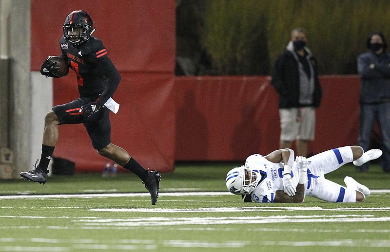 Arkansas State University wide receiver Jonathan Adams Jr. (left) slips away from Georgia State safety Chris Bacon during the fourth quarter of the Red Wolves’ victory over the Panthers on Thursday at Centennial Bank Stadium in Jonesboro. Adams and teammate Dahu Green combined for 24 catches, 349 yards and 4 touchdowns in the victory.
(Arkansas Democrat-Gazette/Thomas Metthe)