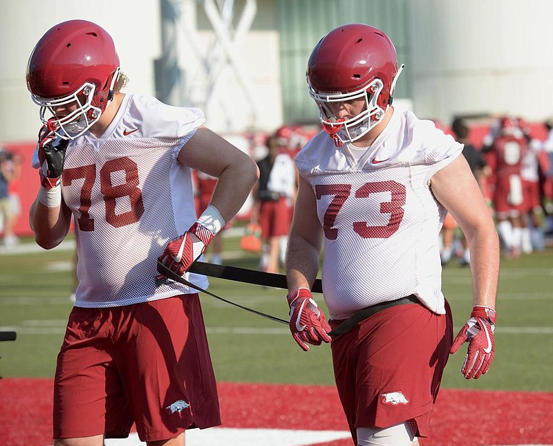 Offensive linemen Dalton Wagner (left) and Noah Gatlin were set up for a position battle in 2019 before Gatlin suffered a torn knee ligament early in training camp. Wagner, who started 12 games at right tackle last season, earned his most substantial playing time of the season after coming in for Gatlin on the second snap of last week’s loss to Auburn.
(NWA Democrat-Gazette/Andy Shupe) story.lead_photo.caption